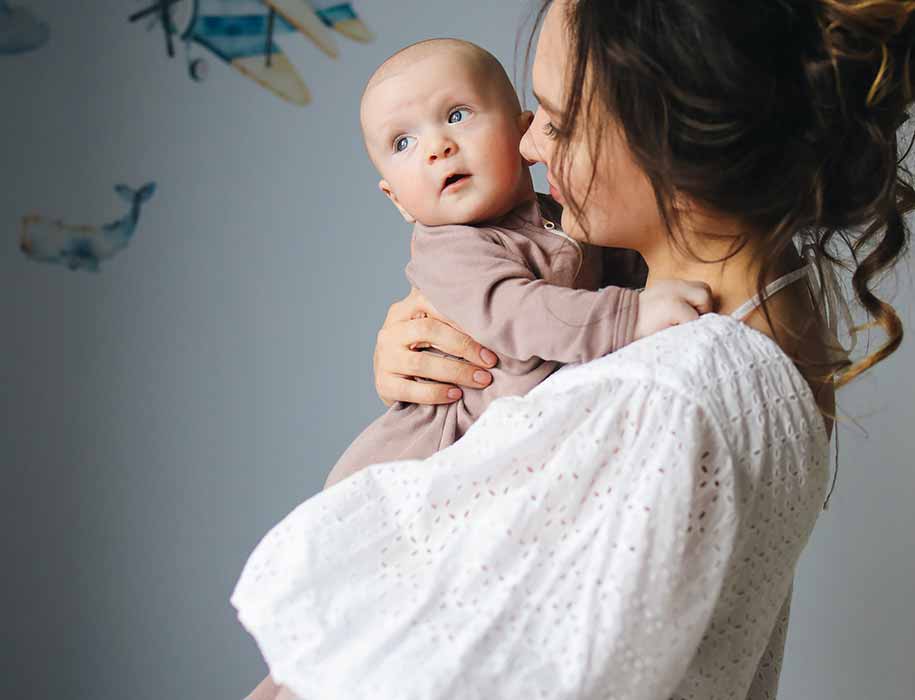 Young mom holding baby.